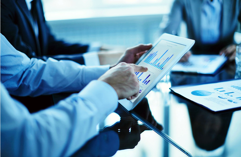 Business advisors reviewing charts on a tablet